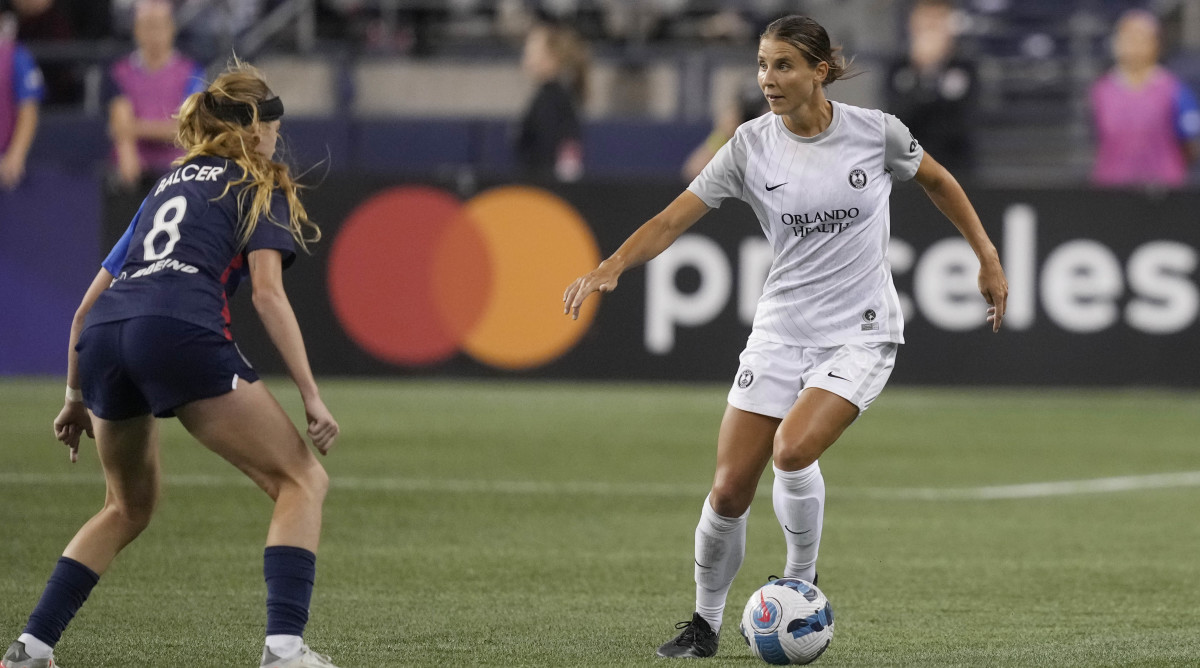 Orlando Pride defender Kylie Strom is defended by OL Reign forward Bethany Balcer in the second half at Lumen Field.